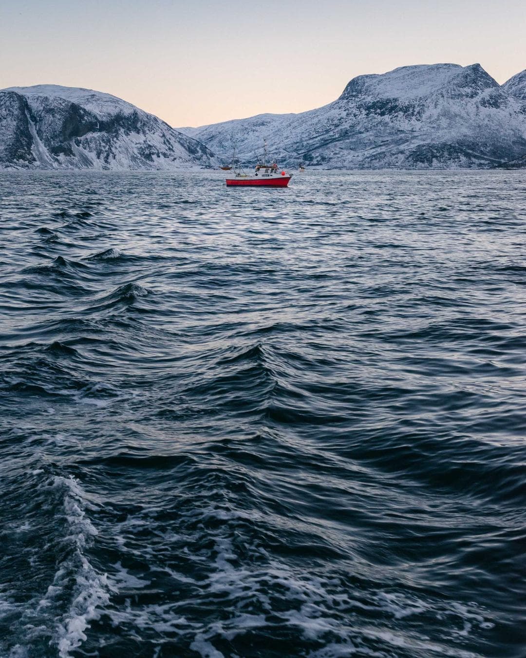 A close-up of a high-end cosmetic product bottle with a purple hue.